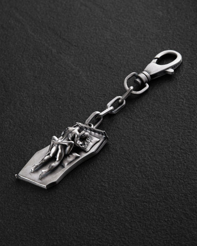 Silver keychain IN BED