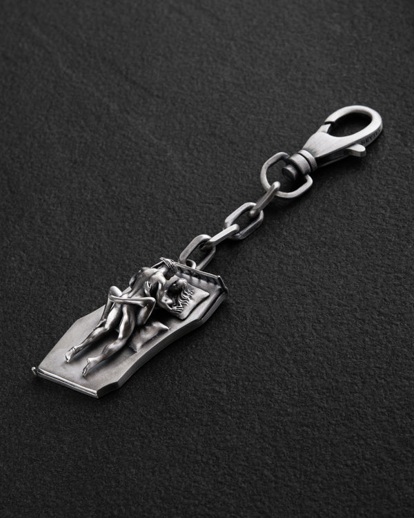 Silver keychain IN BED