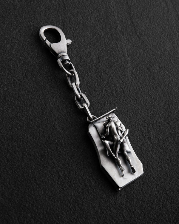Silver keychain IN BED