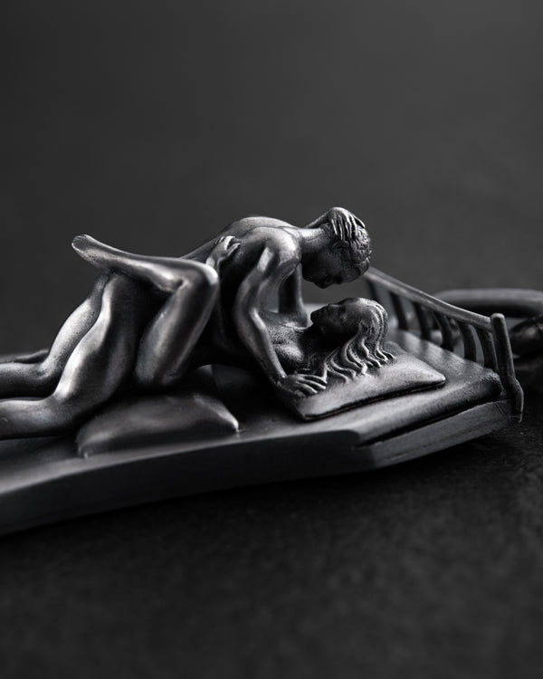 Silver keychain IN BED