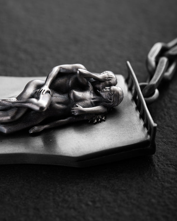 Silver keychain IN BED