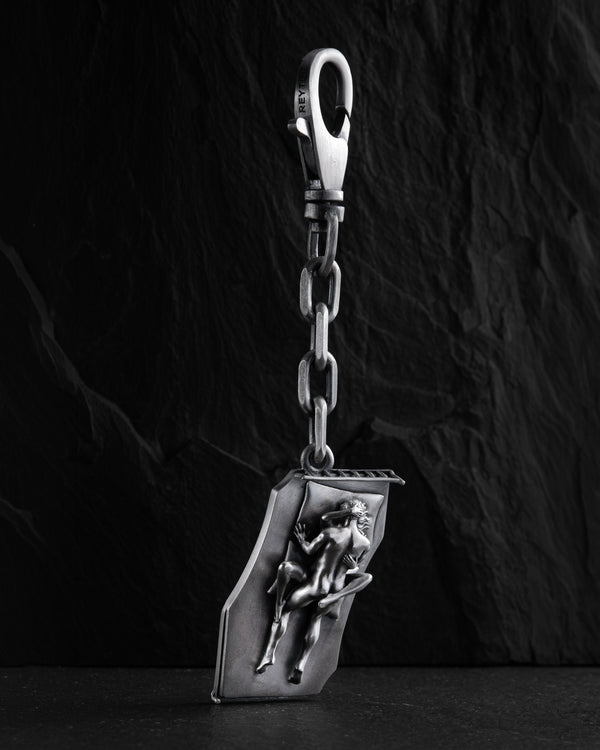 Silver keychain IN BED