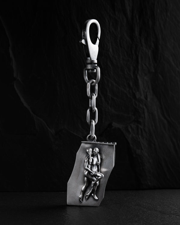 Silver keychain IN BED