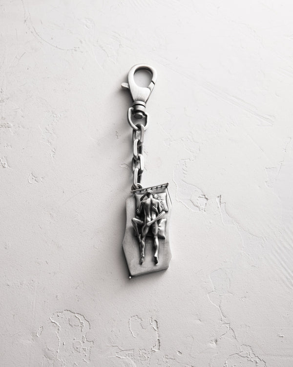 Silver keychain IN BED