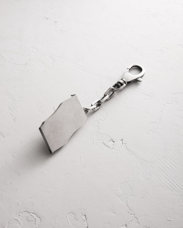 Silver keychain IN BED