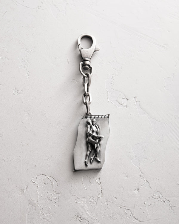 Silver keychain IN BED