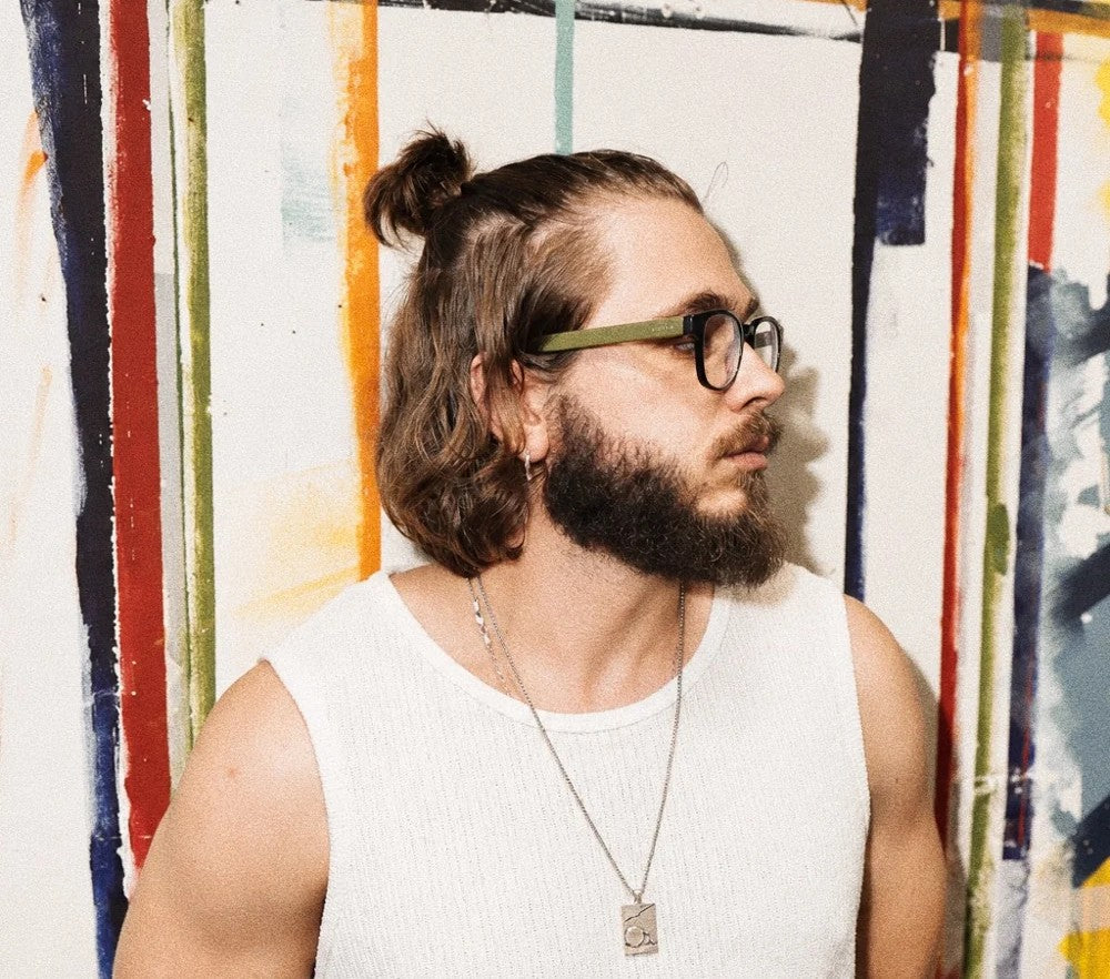 Artur Soletskyi wearing a FRAGMENT pendant